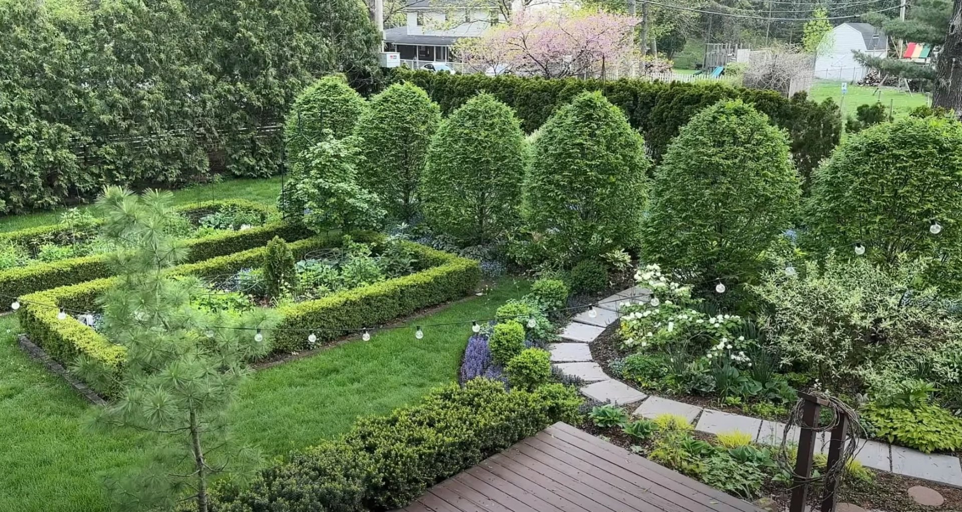Formal landscape design with curved stone pathways and established tree canopy Formal garden with curved pathways and mature trees in Channelview, TX