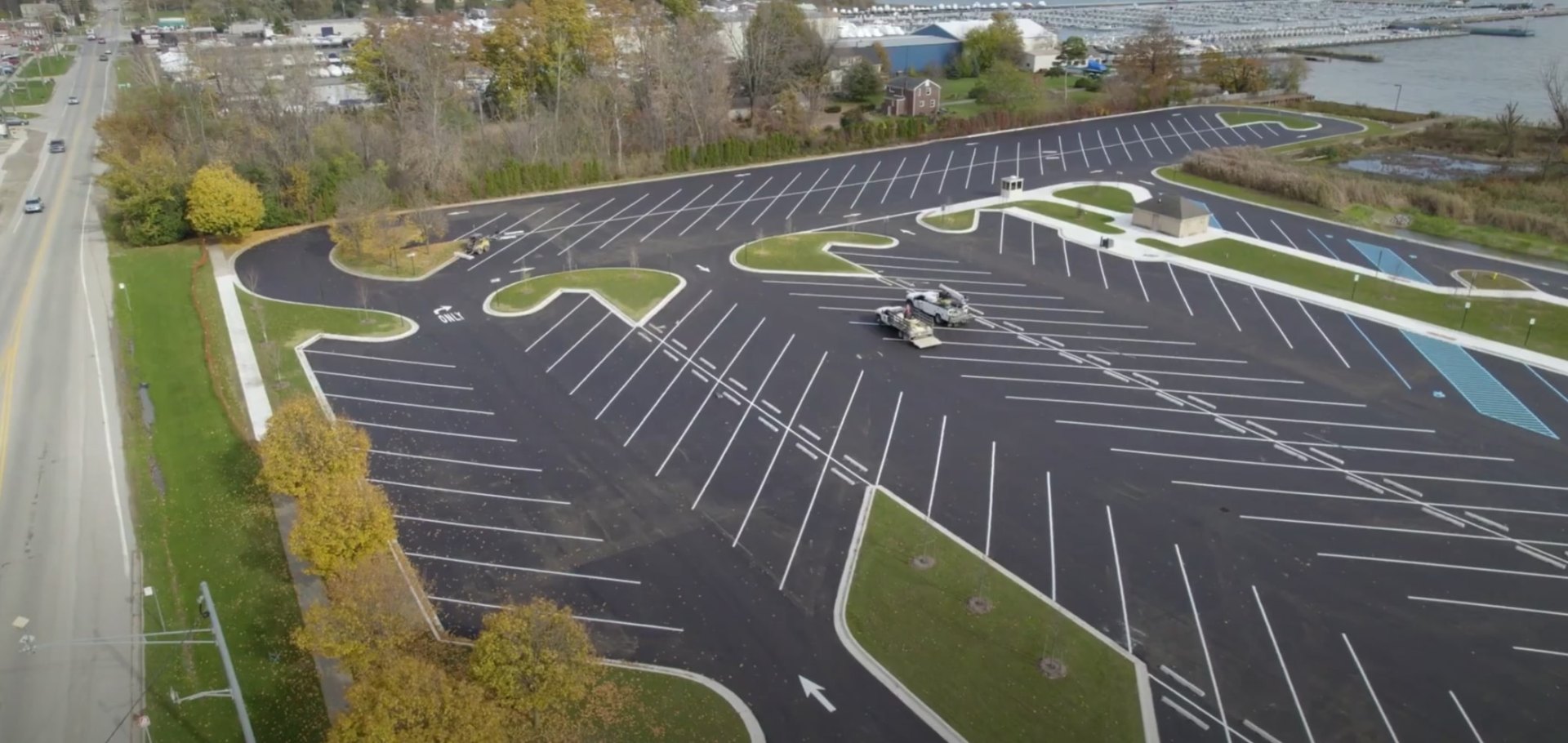 Commercial landscaping and site planning for large-scale properties and parking facilities Large-scale commercial parking lot with organized traffic flow and professional landscaping in Channelview, TX